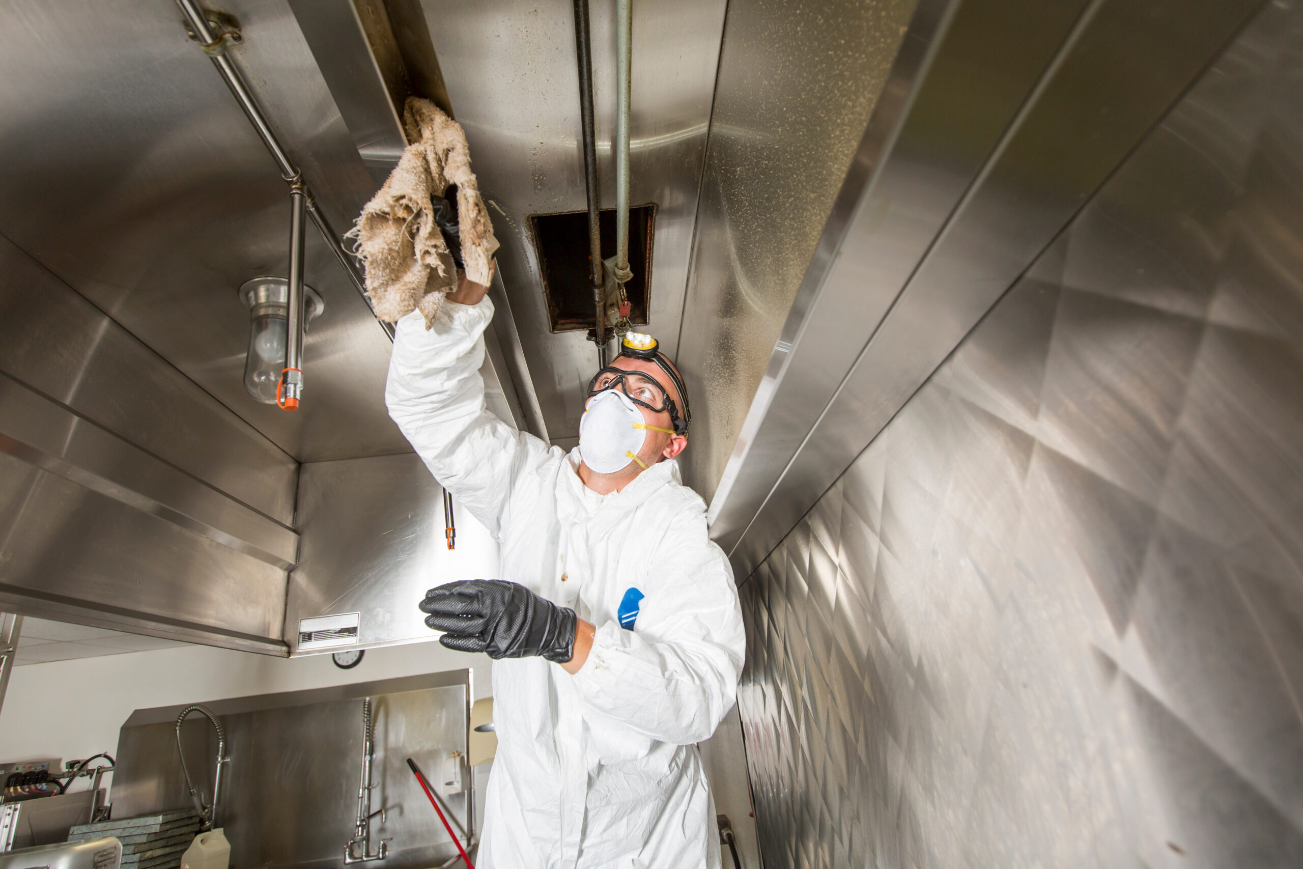 Commercial kitchen worker washing up at sink in professional kitchen Restaurant Cleaning
